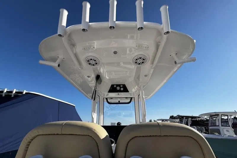 Slide: The Image of 2026 Sportsman Masters 247OE Bay Boat, view of helm and T-top under clear sky. - 17