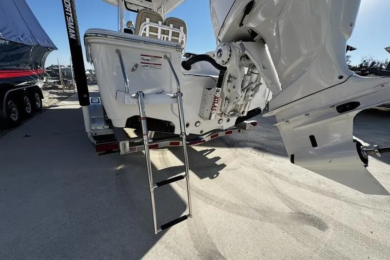 Slide: The Image of 2026 Sportsman Masters 247OE Bay Boat with ladder and outboard motor. - 2