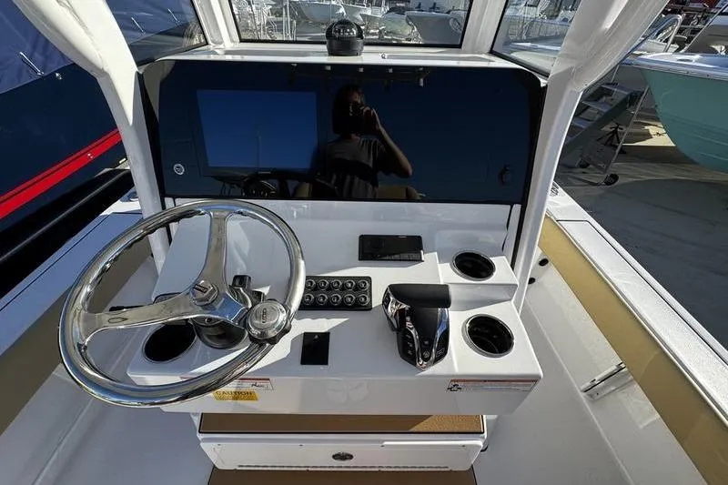 Slide: The Image of 2026 Sportsman Masters 247OE Bay Boat helm with steering wheel and controls. - 20