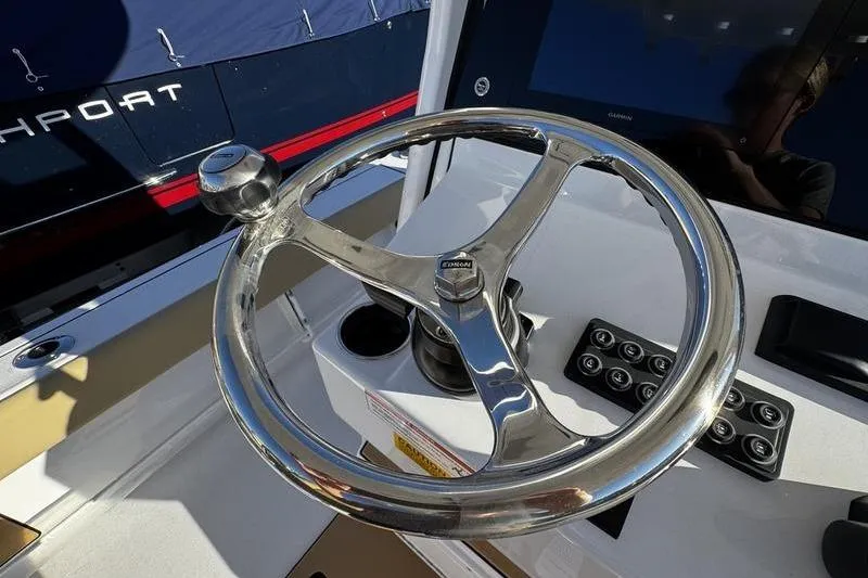 Slide: The Image of 2026 Sportsman Masters 247OE Bay Boat steering wheel and control panel. - 21