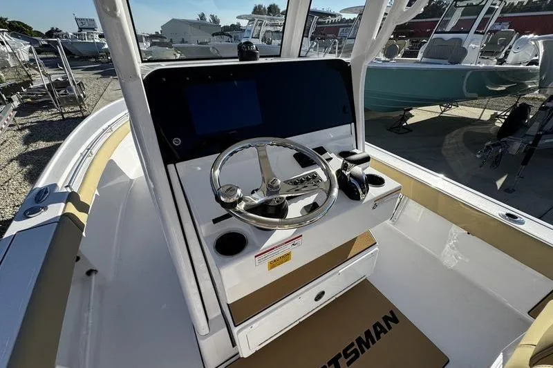 Slide: The Image of 2026 Sportsman Masters 247OE Bay Boat cockpit with steering wheel and controls. - 24