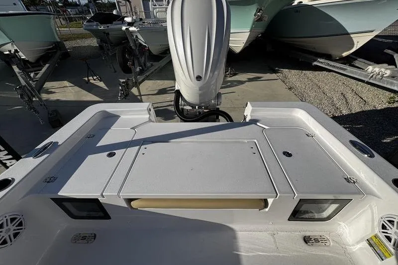 Slide: The Image of 2026 Sportsman Masters 247OE Bay Boat, rear deck view with motor and storage compartments. - 27