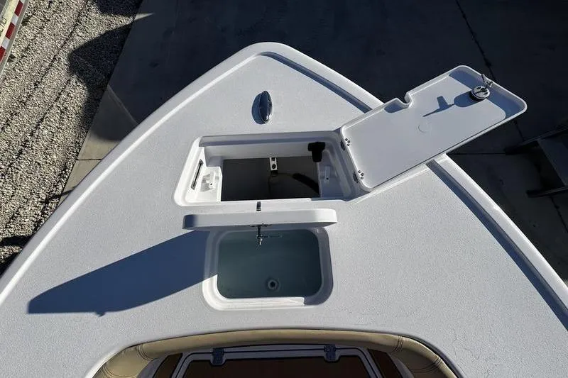 Slide: The Image of 2026 Sportsman Masters 247OE Bay Boat with open storage compartment on deck. - 6