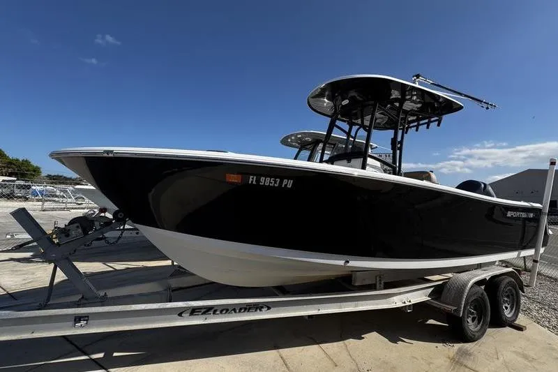 The Image of 2026 Sportsman Open 232 Center Console boat on trailer under clear blue sky. - 1