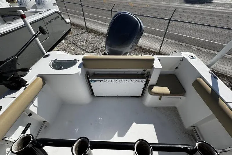 Slide: The Image of 2026 Sportsman Open 232 Center Console boat interior with seating and motor view. - 18