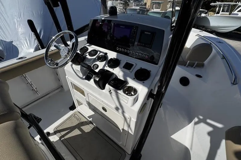 Slide: The Image of 2026 Sportsman Open 232 Center Console boat dashboard with steering wheel and controls. - 19