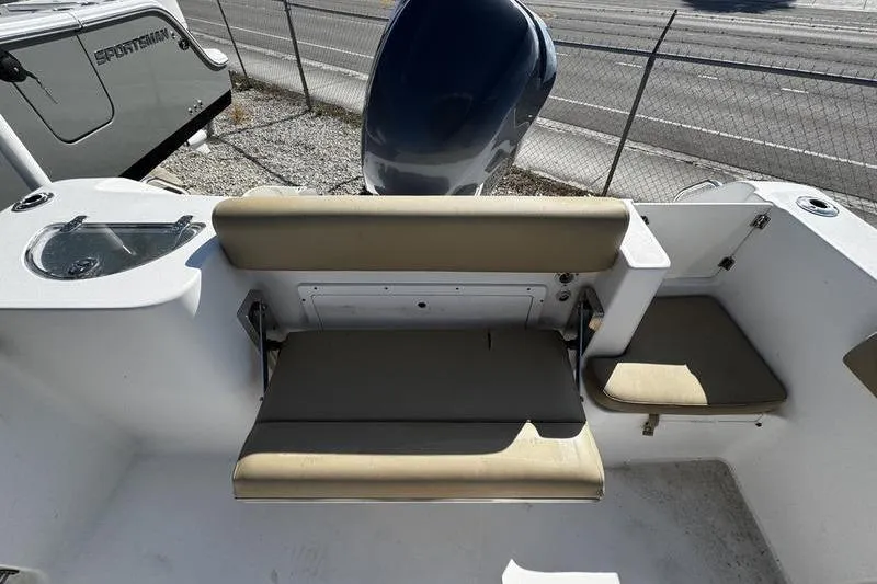 Slide: The Image of 2026 Sportsman Open 232 Center Console boat interior with seating and motor view. - 22