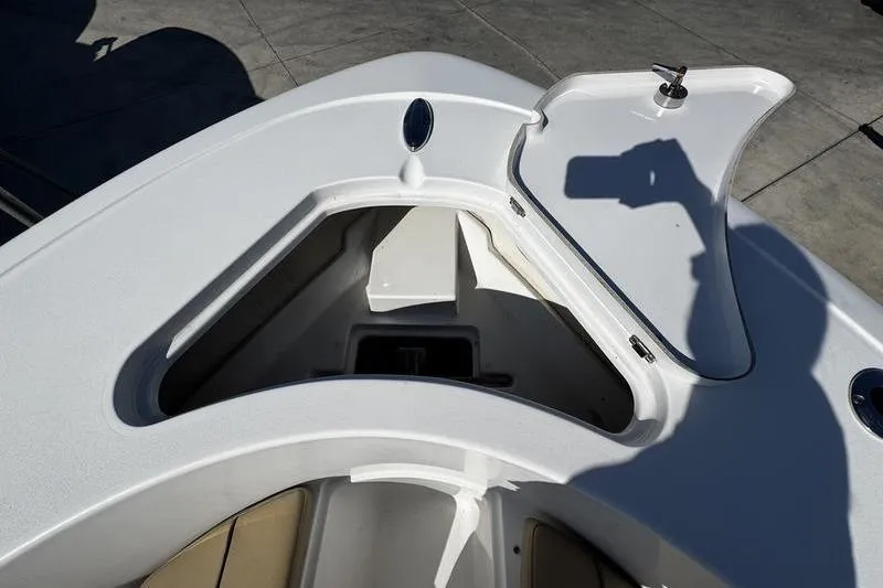 Slide: The Image of 2026 Sportsman Open 232 Center Console boat storage compartment with open hatch. - 10