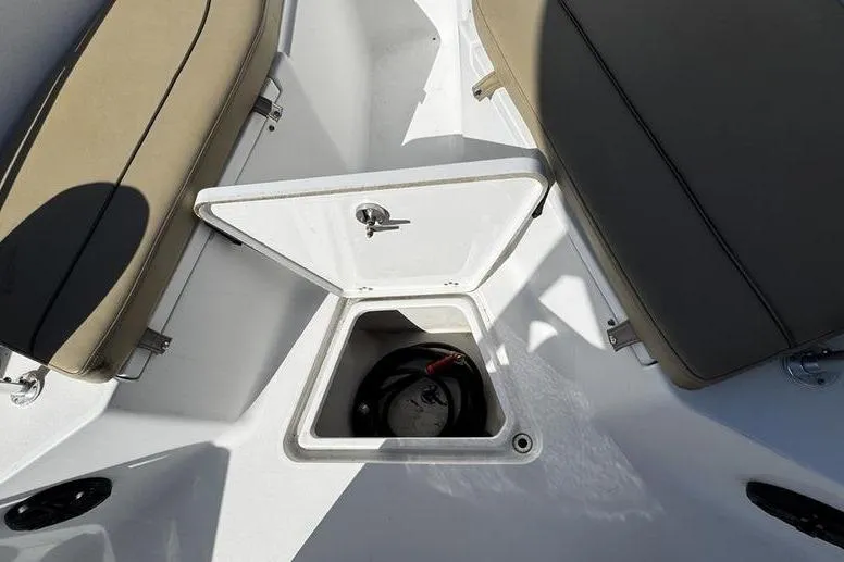 Slide: The Image of 2026 Sportsman Open 232 Center Console storage compartment with open hatch and seating. - 15