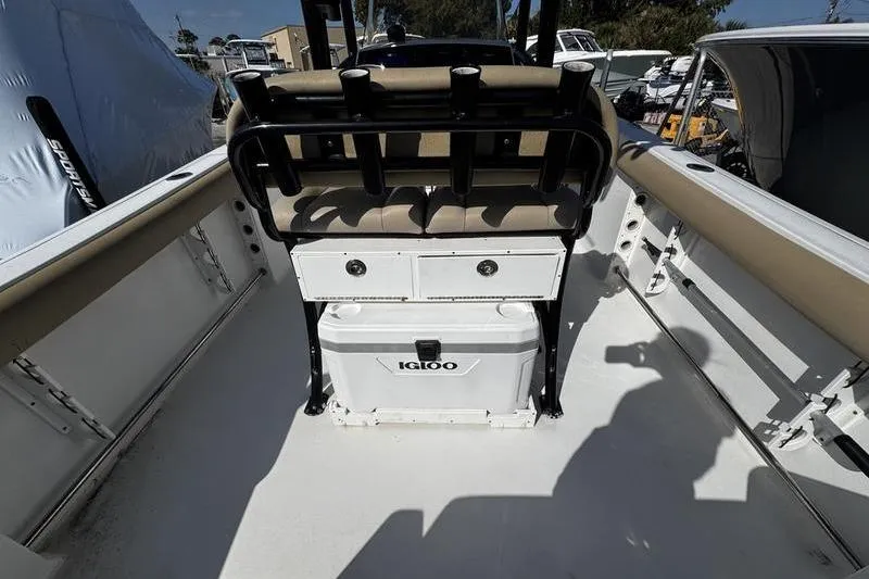 Slide: The Image of 2026 Sportsman Open 232 Center Console boat interior with seating and Igloo cooler. - 20