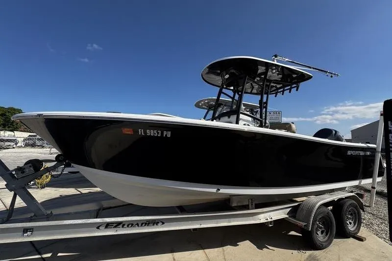 Slide: The Image of 2026 Sportsman Open 232 Center Console boat on trailer under clear blue sky. - 5