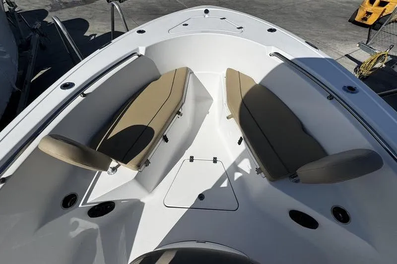 Slide: The Image of 2026 Sportsman Open 232 Center Console boat interior with tan seating and storage compartments. - 8