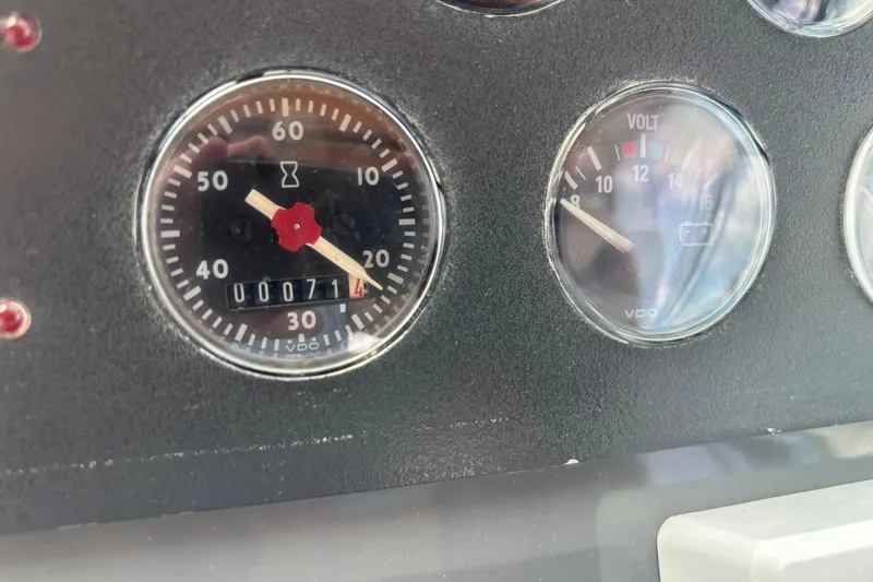 Slide: The Image of Dashboard gauges of a 1998 Tiara Yachts 2900 Coronet, showing hours and voltage. - 10