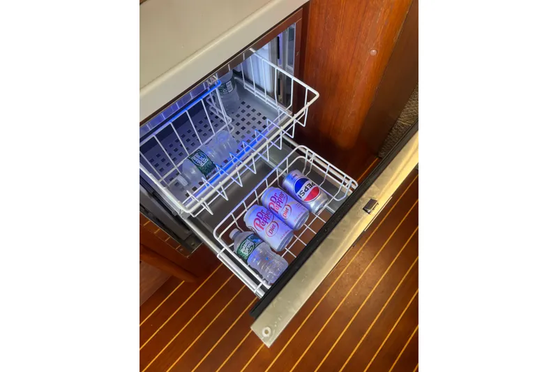 Slide: The Image of Mini fridge on 1998 Tiara Yachts 2900 Coronet with drinks and water bottles. - 26