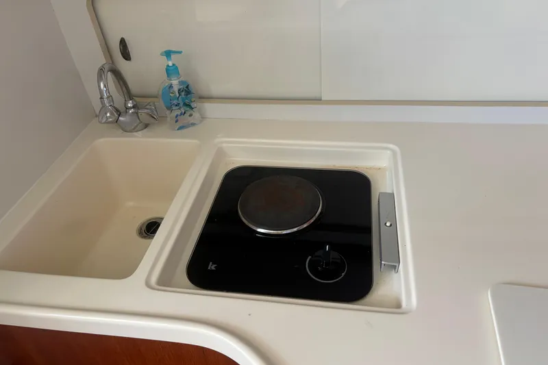 Slide: The Image of 1998 Tiara Yachts 2900 Coronet kitchen with sink and stove. - 29