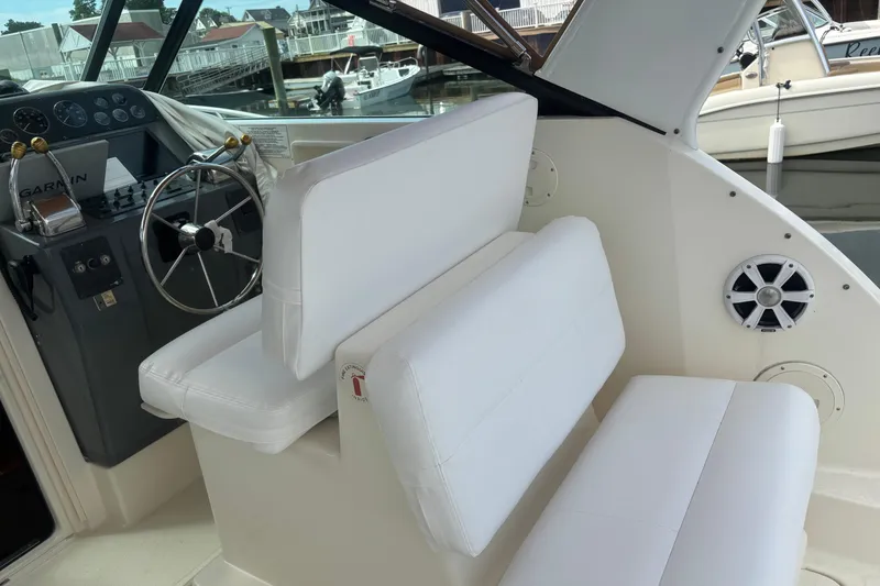 Slide: The Image of 1998 Tiara Yachts 2900 Coronet interior with white seating and steering wheel. - 35