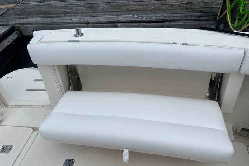 Slide: The Image of 1998 Tiara Yachts 2900 Coronet boat with white cushioned seating on deck. - 37