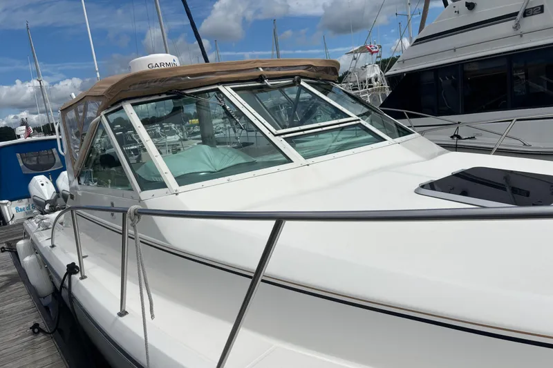 Slide: The Image of 1998 Tiara Yachts 2900 Coronet docked, featuring sleek design and spacious deck. - 40
