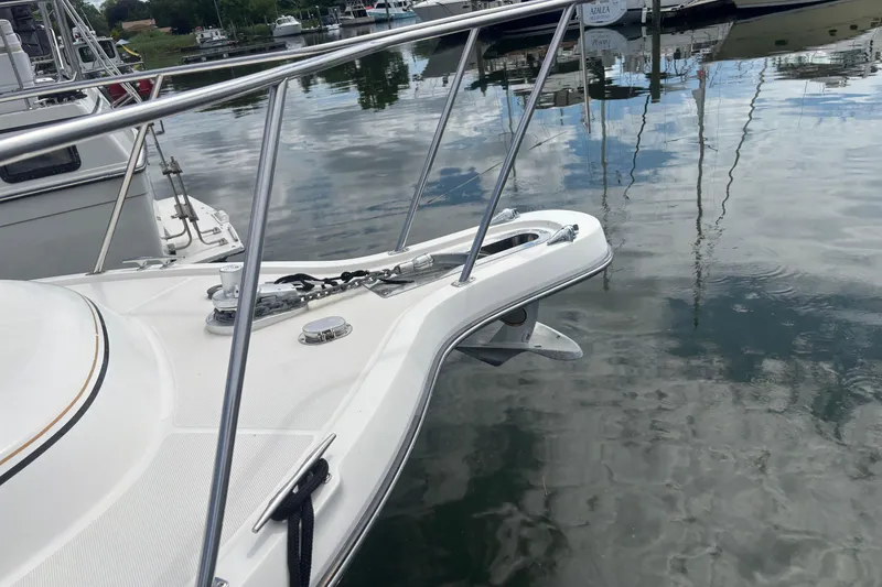 Slide: The Image of 1998 Tiara Yachts 2900 Coronet bow with anchor, docked on calm water. - 41