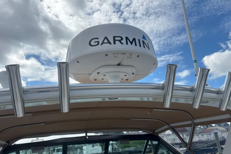 Slide: The Image of 1998 Tiara Yachts 2900 Coronet with Garmin radar, docked under a cloudy sky. - 42