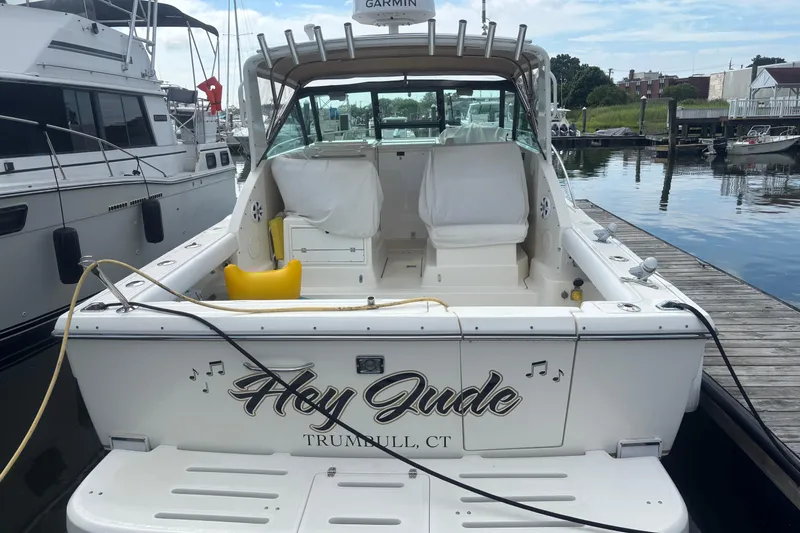 Slide: The Image of 1998 Tiara Yachts 2900 Coronet docked, rear view with "Hey Jude" nameplate. - 9