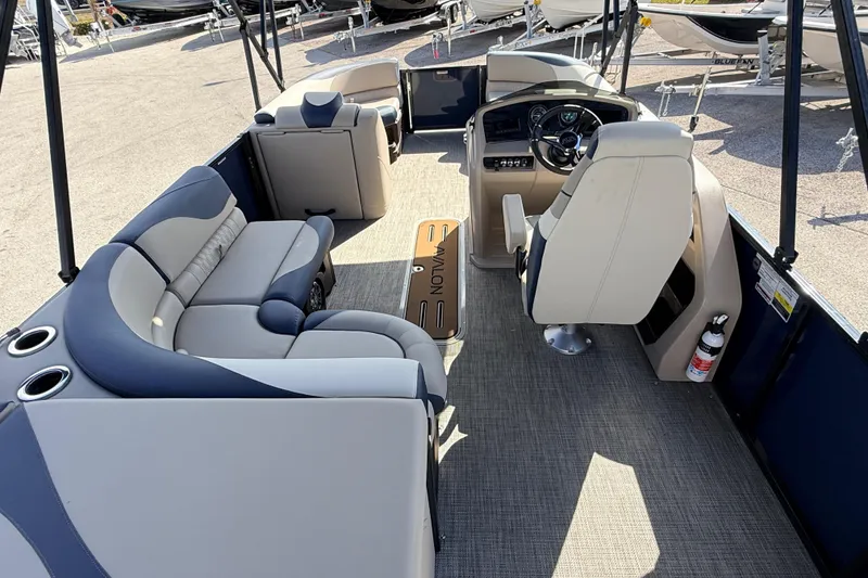 Slide: The Image of 2026 Avalon LSZ Rear Fish 24' pontoon boat interior with plush seating and steering console. - 13