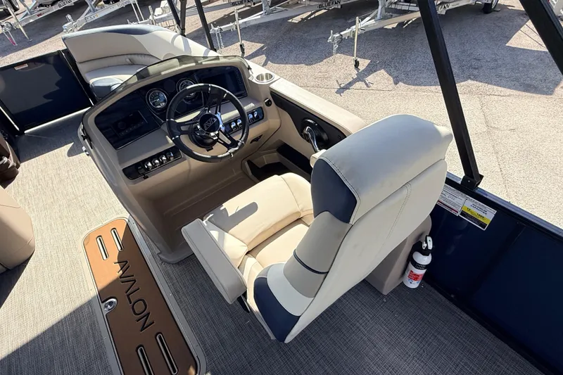 Slide: The Image of Interior of 2026 Avalon LSZ Rear Fish boat, featuring helm and seating area. - 14