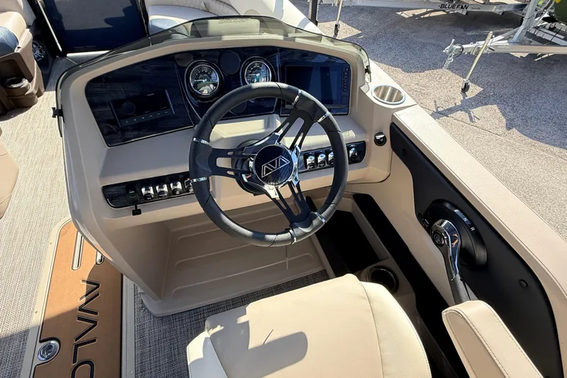 Slide: The Image of 2026 Avalon LSZ Rear Fish 24' boat dashboard with steering wheel and controls. - 24