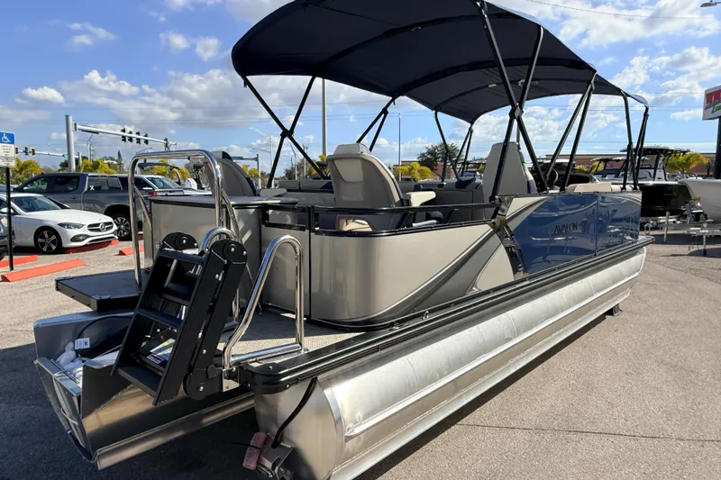 Slide: The Image of 2026 Avalon LSZ Rear Fish 24' pontoon boat with canopy, parked outdoors. - 6