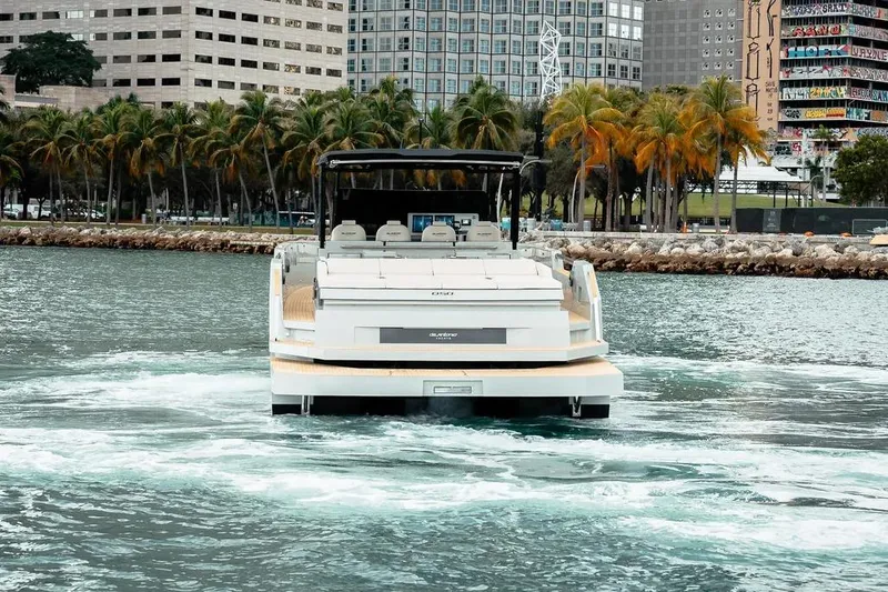 Slide: The Image of De Antonio Yachts D50 OPEN 2026 on water with city backdrop. - 3