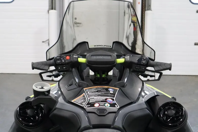Slide: The Image of 2026 Sea-Doo Explorer Pro 170 dashboard with handlebars and controls in a garage setting. - 10