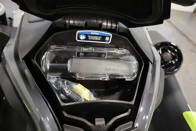 Slide: The Image of 2026 Sea-Doo Explorer Pro 170 storage compartment with accessories and user notice. - 20