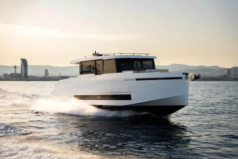 Slide: The Image of De Antonio Yachts D60 2026 cruising on water at sunset. - 11
