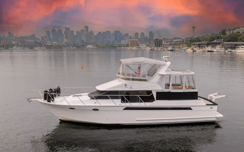 Slide: The Image of 1991 Ocean Alexander 440 Sundeck CPMY against city skyline at sunset. - 1