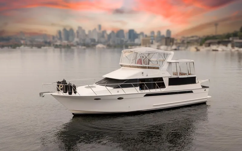 Slide: The Image of 1991 Ocean Alexander 440 Sundeck CPMY with city skyline at sunset. - 2