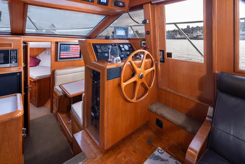 Slide: The Image of Interior of 1991 Ocean Alexander 440 Sundeck CPMY, featuring wood paneling and steering wheel. - 22