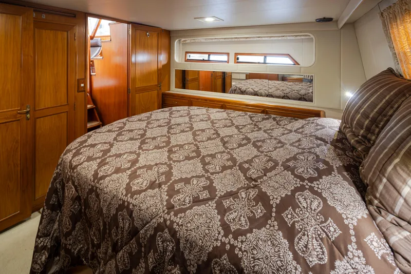 Slide: The Image of Bedroom on Ocean Alexander 440 Sundeck CPMY, 1991, featuring wooden furnishings. - 37
