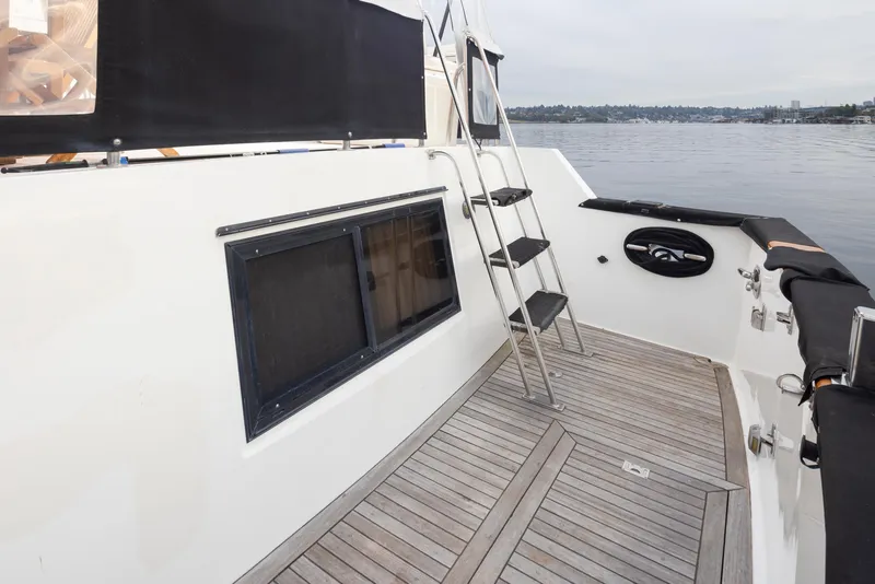 Slide: The Image of 1991 Ocean Alexander 440 Sundeck CPMY, deck view with ladder and window. - 8