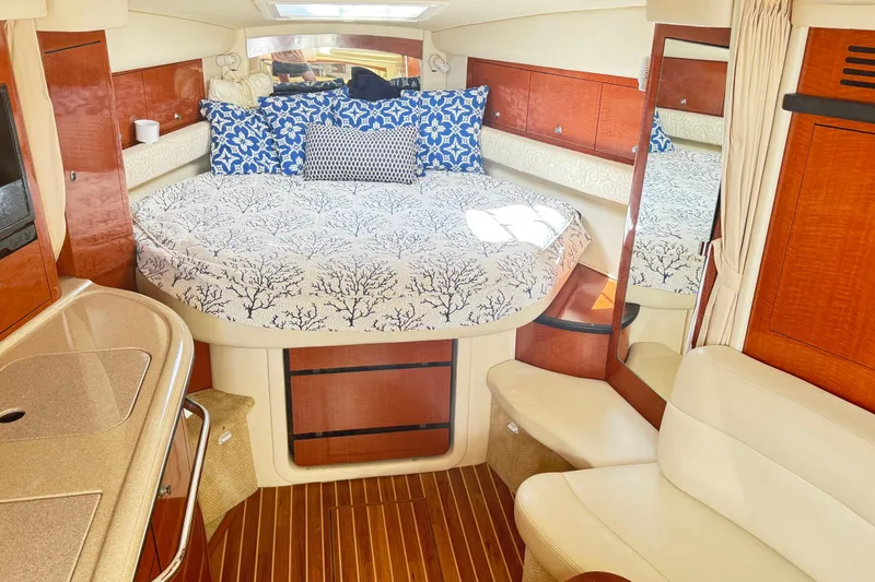 Slide: The Image of Luxurious interior of 2005 Sea Ray 340 Sundancer with elegant bedding and wood finishes. - 10