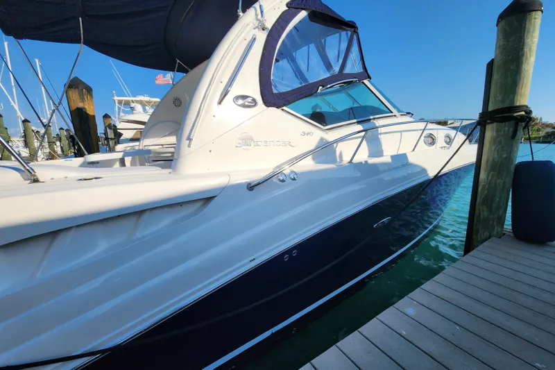 Slide: The Image of 2005 Sea Ray 340 Sundancer docked, showcasing sleek design and luxurious features. - 3