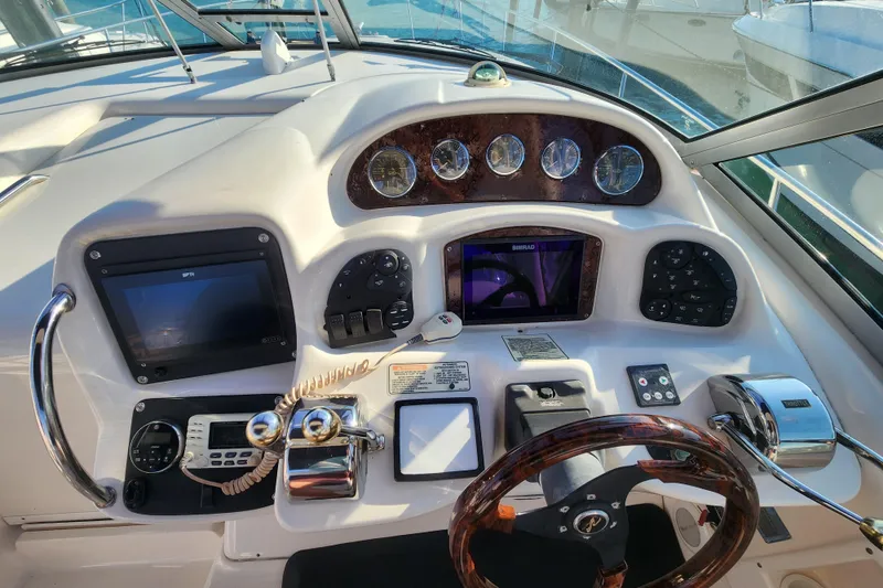 Slide: The Image of Control panel of a 2005 Sea Ray 340 Sundancer boat with navigation instruments. - 6
