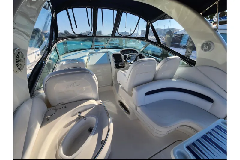 Slide: The Image of 2005 Sea Ray 340 Sundancer cockpit with white seating and modern dashboard. - 7