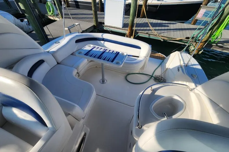 Slide: The Image of 2005 Sea Ray 340 Sundancer boat interior with seating and table at dock. - 8