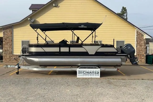The Image of 2026 Veranda VR235F2 pontoon boat parked in front of a yellow building. - 0