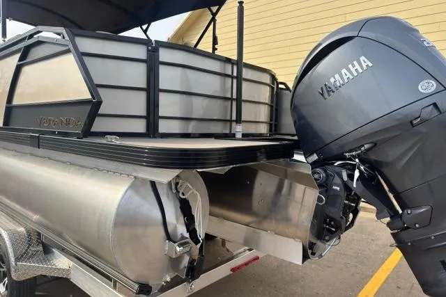 Slide: The Image of 2026 Veranda VR235F2 pontoon boat with Yamaha outboard motor, parked on a trailer. - 10