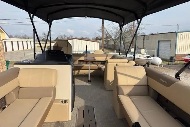 Slide: The Image of 2026 Veranda VR235F2 pontoon boat interior with beige seating and canopy. - 3