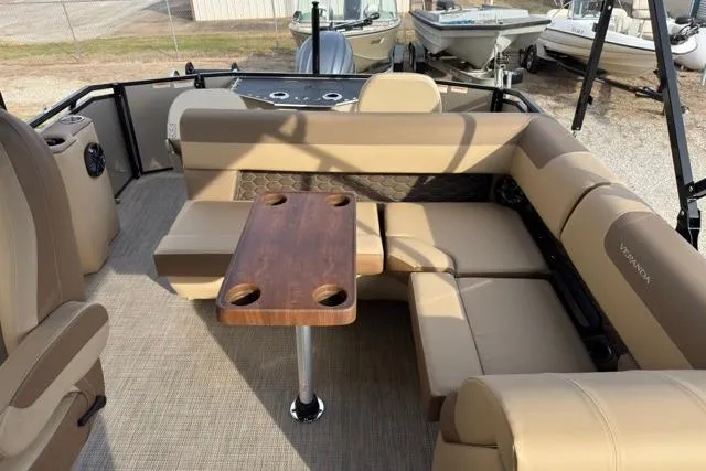 Slide: The Image of Luxurious 2026 Veranda VR235F2 pontoon boat interior with plush seating and wooden table. - 5