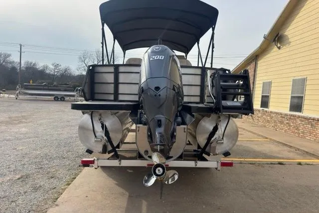 Slide: The Image of 2026 Veranda VR235F2 pontoon boat with powerful 200 HP engine, parked outdoors. - 8