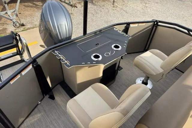 Slide: The Image of 2026 Veranda VR235F2 boat interior with helm, seating, and motor. - 9