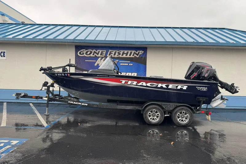 The Image of 2025 Tracker Targa V-19 WT boat on trailer, parked outside a fishing store. - 1